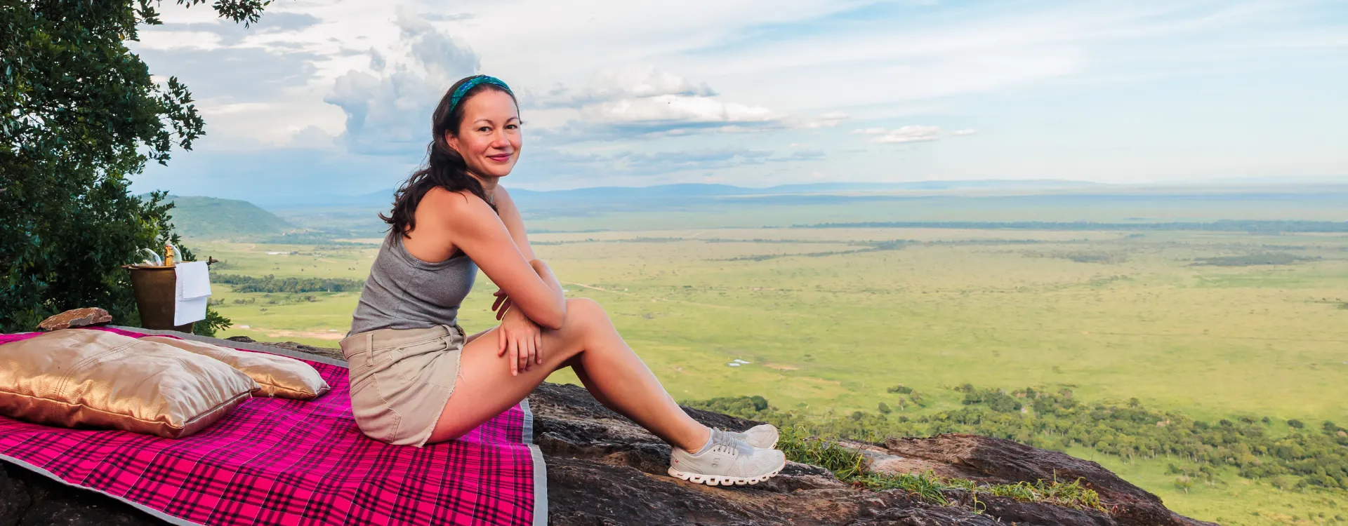 A woman sitting on a rock in the Maasai Mara